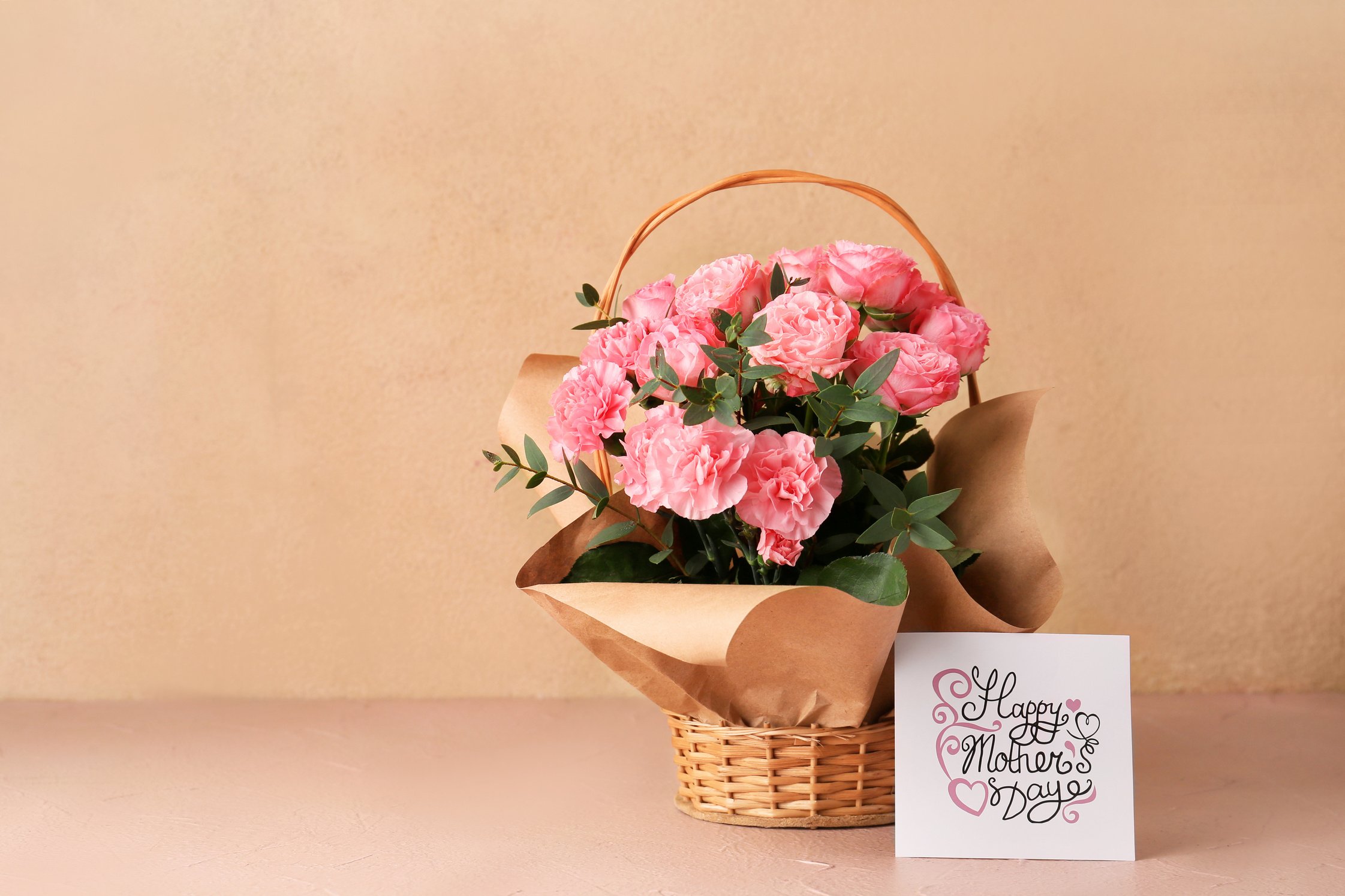 Basket with Bouquet for Mother's Day on Table